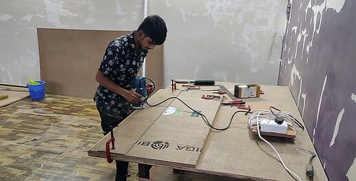 Ali creating the rabbet at the edge of the planks using a router.